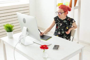 Tasarımcı, yaratıcı, insan kavramı - kırmızı saçlı kadın tasarımcı grafik tablet üzerinde bir proje yapıyor