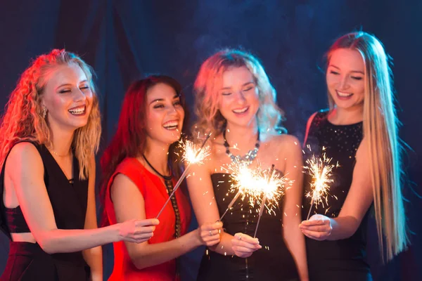 Party, holidays, new year, christmas and nightlife concept - happy young women dancing at night club disco, close-up — Stock Photo, Image