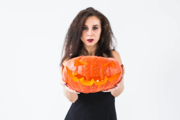 Halloween and masquerade concept - Beautiful young woman posing with Pumpkin Jack-o-lantern — Stock Photo, Image