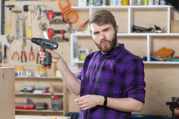 Young bearded man working at the furniture factory — Stock Photo, Image