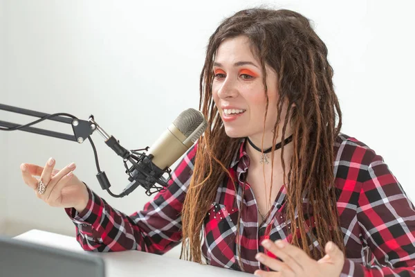 Radio host, blogging and broadcast concept - Modern party girl DJ in bright clothes and with dreadlocks — Stock Photo, Image