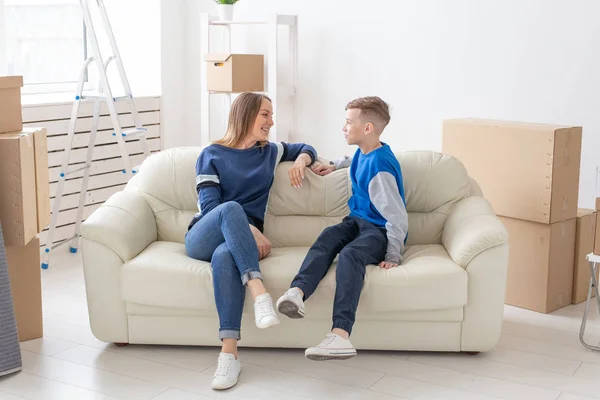 Satisfied happy caucasian single mother and son happily communicate discussing the design of the new apartment during the housewarming party. — Stock Photo, Image