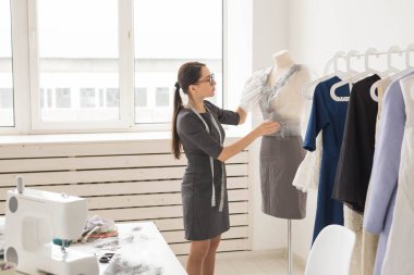 Terzi, terzi, moda ve showroom konsept - kadın moda tasarımcısı manken ofis malzemeleri ölçme yan görünüm
