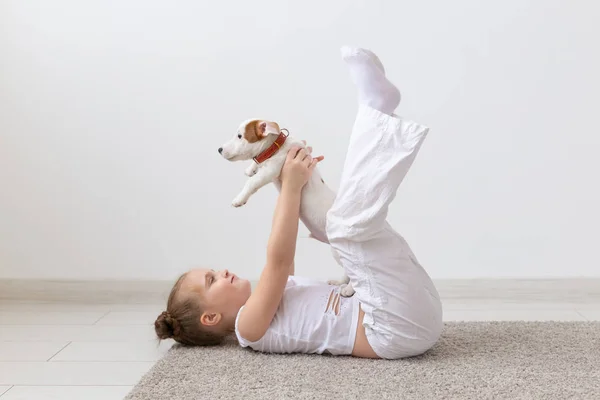 사람, 어린이와 애완 동물 개념-귀여운 강아지 잭 러셀 테리어와 바닥에 누워 작은 아이 소녀 — 스톡 사진