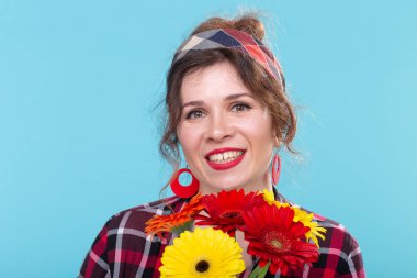 Vintage, moda ve çiçekçi kavramı - kopya alanı ile mavi arka plan retro tarzı nda eğlenmek gerberas ile kadın.