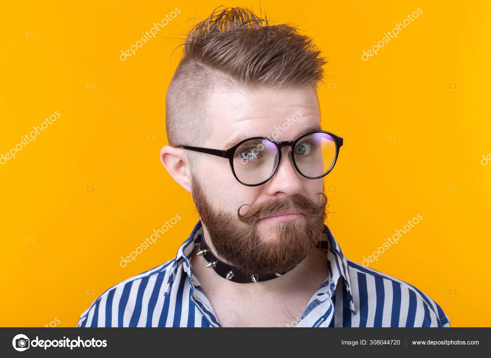 Young positive trendy man hipster with a mustache beard and fetish