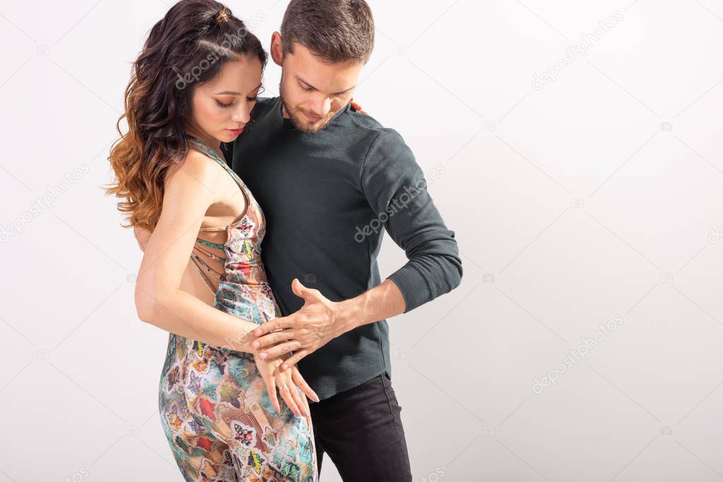 Salsa, kizomba and bachata dancers on white background with copy space. Social dance concept