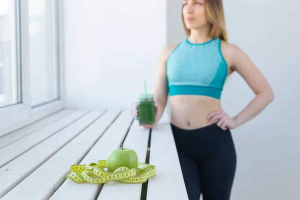 Healthy, sport, diet and people concept - Successful fitness urban woman recommending detox smoothie, close-up