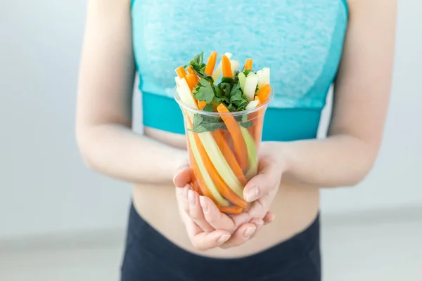 Conceito de dieta - close-up de mulher de estilo de vida saudável que mantém verduras em casa. Jovem do sexo feminino comer alimentos saudáveis . — Fotografia de Stock