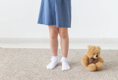 Beyaz bir arka plan üzerinde mavi polka nokta elbise poz Büyüleyici küçük kız. Klasik çocuk giyim ve şık çocuk kavramı.