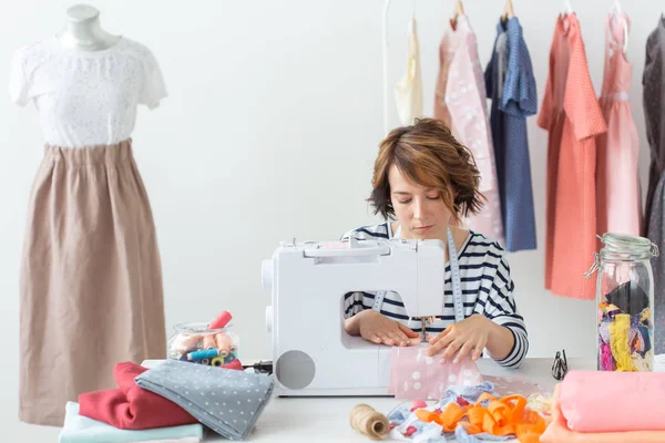 Clothing designer, seamstress, people concept - woman seamstress working in her studio — Stock Photo, Image