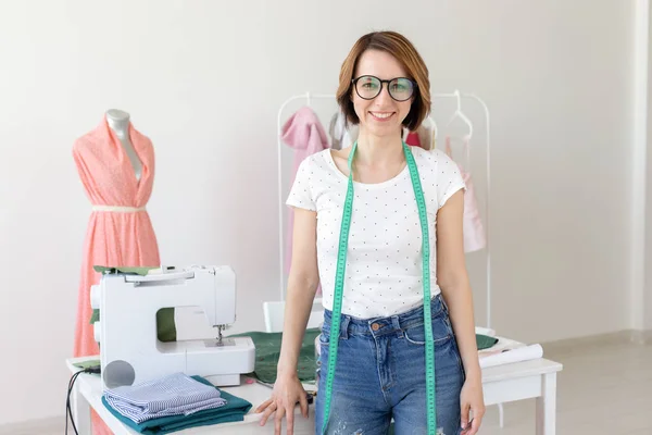 Dressmaker, fashion designer, tailor and people concept - Beautiful fashion woman designer standing in studio