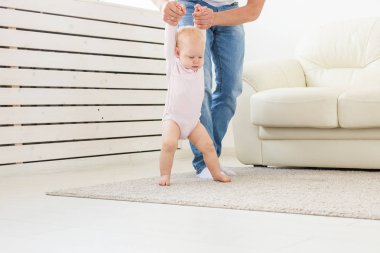 Küçük kız bebek baba yardımı ile ilk adımlar