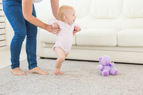 Little baby girl first steps with the help of mom — Stock Photo, Image