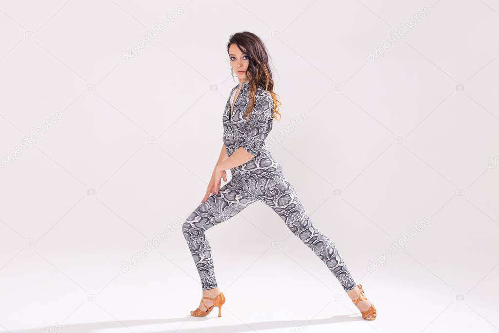Latin dance, bachata lady, jazz modern and vogue dance concept - Beautiful young woman dancing on white background with copy space