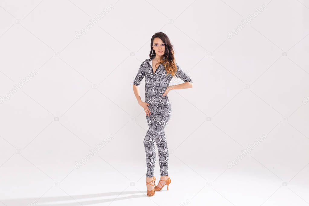 Latin dance, bachata lady, jazz modern and vogue dance concept - Beautiful young woman dancing on white background with copy space