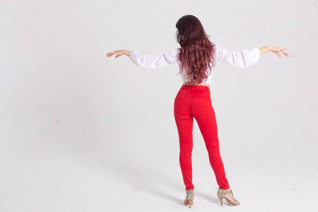 Latina dance, strip dance, contemporary and bachata lady concept - Woman dancing improvisation and moving her long hair on a white background