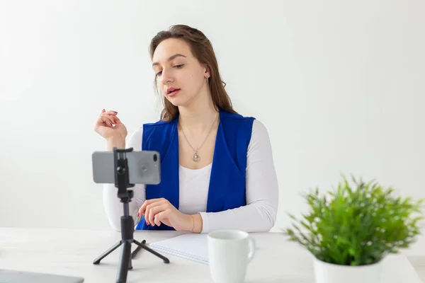 Blogging and vlog concept - young woman blogger talking on the camera — Stock Photo, Image