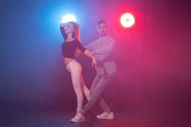 Sosyal dans, bachata, salsa, kizomba, zouk ve tango kavramı - Erkek ışıklar üzerinde dans ederken kadın kucaklar