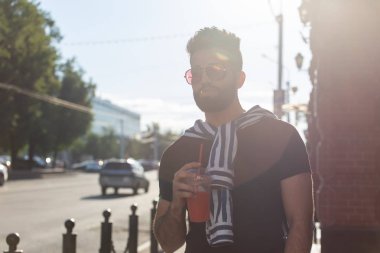 Suyu ile şık bir genç hipster Arap erkek Portresi. Hafta sonu konseptinde şehir tatili.