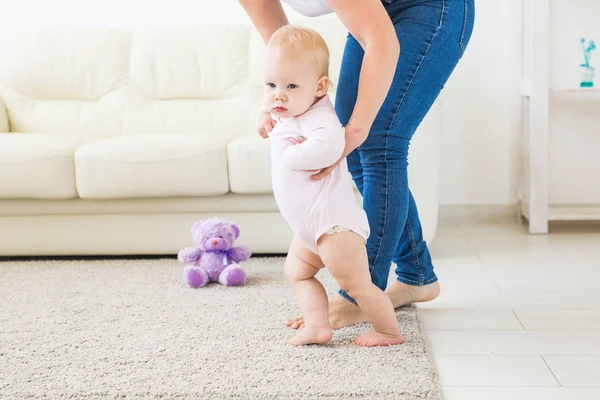 Little baby girl first steps with the help of mom — Stock Photo, Image