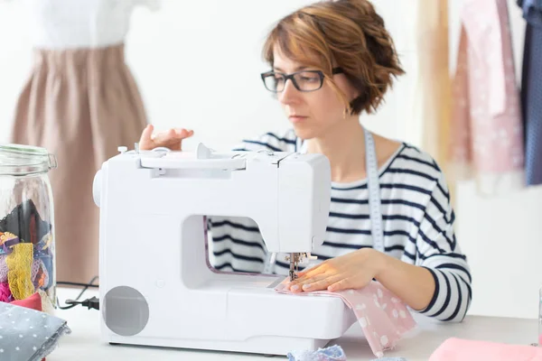Clothing designer, seamstress, people concept - clothing designer working in her studio — Stock Photo, Image