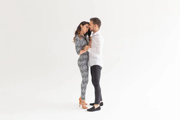 Casal jovem dançando bachata dança latina social, merengue, salsa. Dois pose elegância no fundo branco — Fotografia de Stock