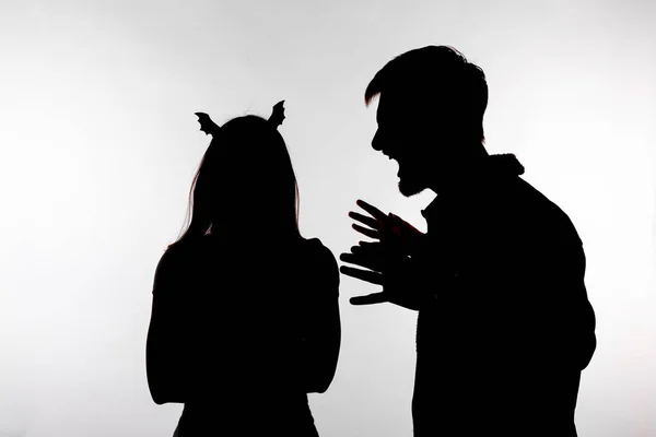 Casal homem gritando com mulher gritando disputa em silhueta estúdio isolado em fundo branco. Mulher com orelhas de morcego, Halloween — Fotografia de Stock