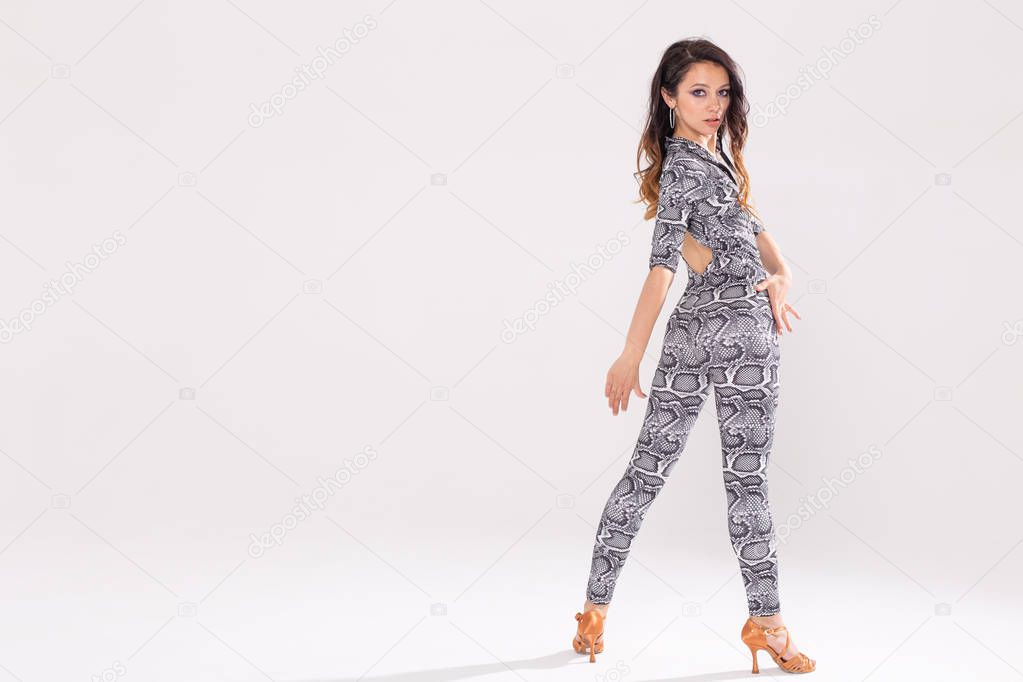 Latin dance, bachata lady, jazz modern and vogue dance concept - Beautiful young woman dancing on white background with copy space