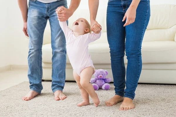 First steps of baby toddler learning to walk in white sunny living room — Stock Photo, Image