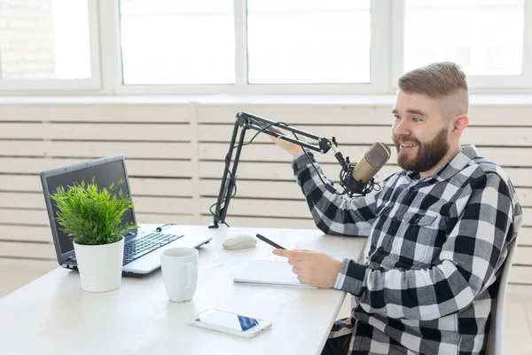 Radio, DJ, blogging and people concept - man working as a DJ on the radio