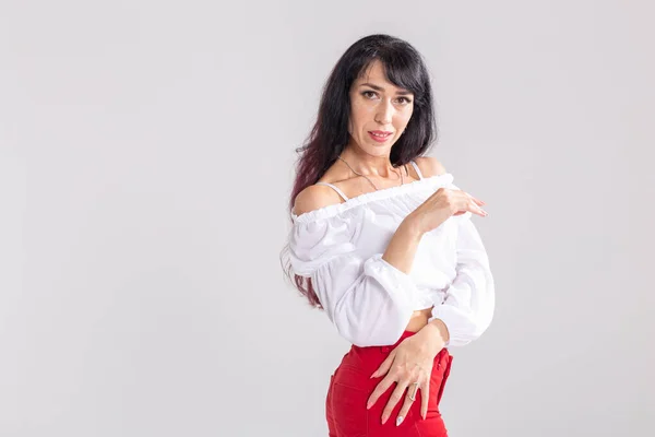 Latina dance, strip dance, contemporary and bachata lady concept - Woman dancing improvisation and moving her long hair on a white background with copy space