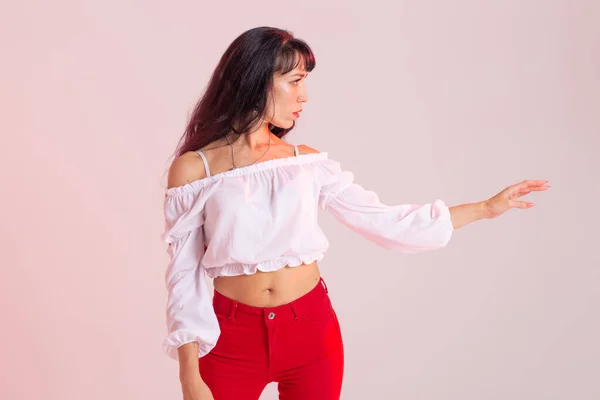 Latina dance, strip dance, contemporary and bachata lady concept - Woman dancing improvisation and moving her long hair on a background
