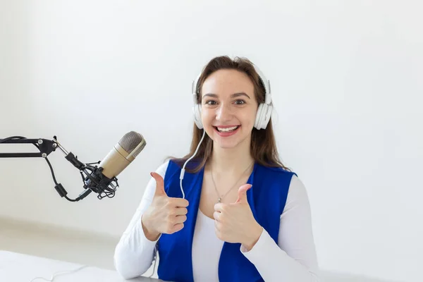 Radio, blogging, broadcast concept - Young woman working on the radio and showing thumbs up — Stock Photo, Image