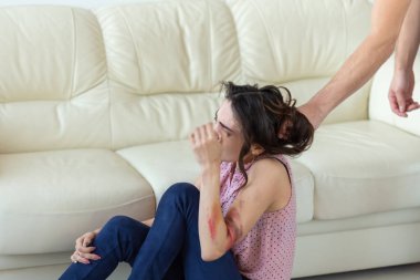 Aile içi şiddet, kurban ve kötüye kavramı - acımasız agresif adam kapma kadın yerde yatarken