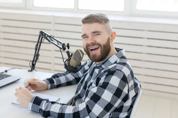 Radio, dj, blogger and people concept - young handsome dj at home studio