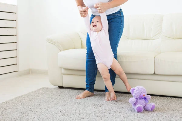 Little baby girl first steps with the help of mom — Stock Photo, Image