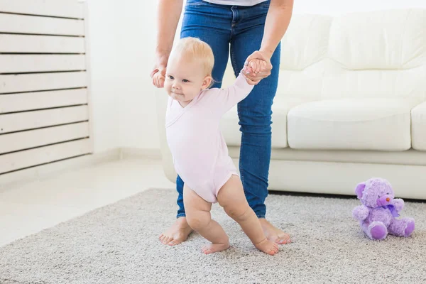 First steps. Little baby girl learning to walk. — Stock Photo, Image