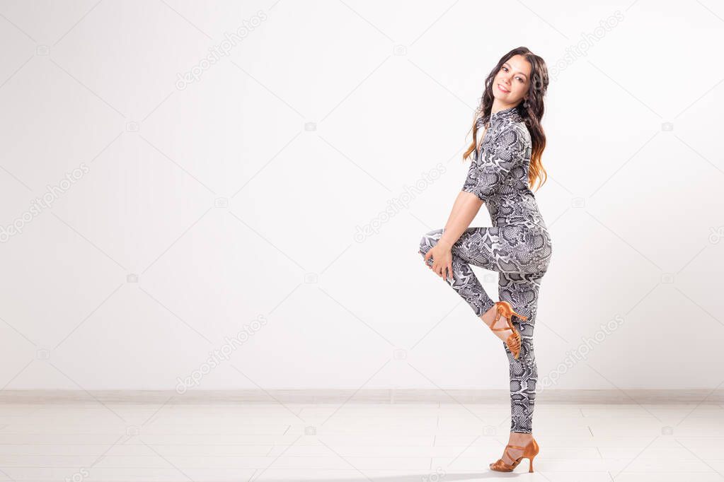 Latin dance, bachata lady, jazz modern and vogue dance concept - Beautiful young woman dancing on white background with copy space