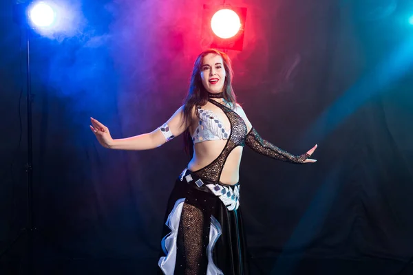 Young woman dancing in Tribal Fusion style. Belly dance on the stage. — Stock Photo, Image