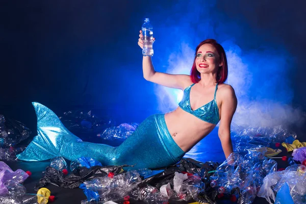 Fantasy stupid mermaid in deep ocean. Plastic trash and bottles pollution in ocean. Ecocatastrophe, garbage and plastic recycling concept. — Stock Photo, Image