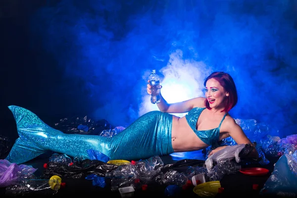 Fantasy stupid mermaid in deep ocean. Plastic trash and bottles pollution in ocean. Ecocatastrophe, garbage and plastic recycling concept. — Stock Photo, Image