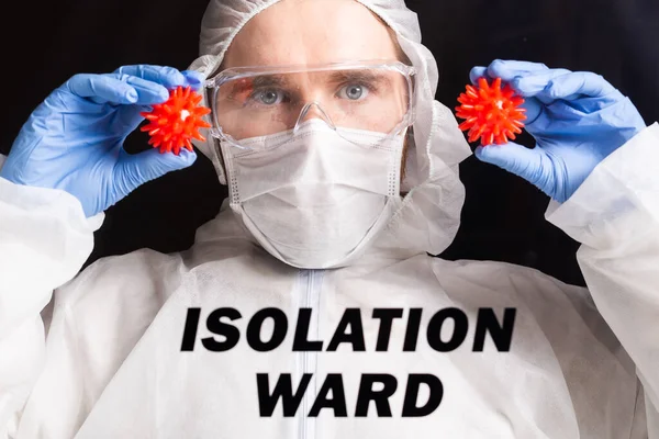 Man in protective suit and in protective medical mask showing stop gesture. Epidemiologist portrait. Stop coronavirus or covid-19 and the pandemic. Stay home. Quarantine and isolation ward concept.