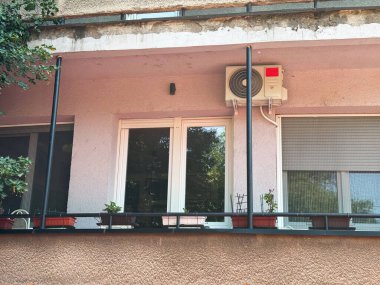 Dış havalandırma ünitesi ve basit kentsel tesisleri olan balkon manzaralı. Mimarlık, konut ve şehir yaşam tarzıyla konut inşaatı ve mahalle çevresi