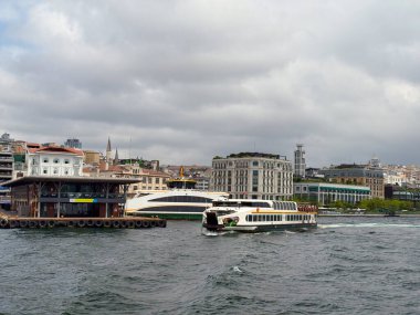 Tarihi otel ve modern binalarla şehir liman manzarası. İstanbul 'da turizm, kentsel yaşam tarzı ve mimari çeşitlilik