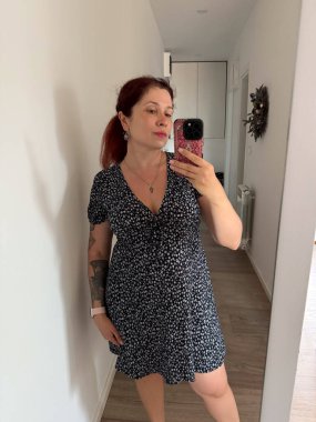 İçerde siyah çiçekli elbiseyle selfie çeken bir kadın. Moda tarzı, kişisel kimlik ve günlük görünüş güzellik, yaşam tarzı ve kendini ifade etme.