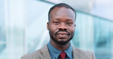 Düz dışarıda fotoğraf makinesi içine yakışıklı genç Afro-Amerikalı işadamı görünüyor