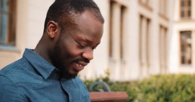 Tezgah üzerinde Afro-Amerikan bussinesman oturur ve inşaat üstünde onun laptop kapat