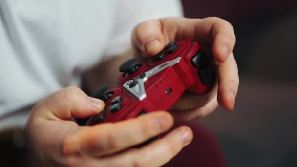 Fat man holds a gamepad in his arms, close-up, plays the game console. Concept of video game — Stock Video