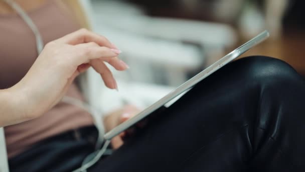 Primer plano de las mujeres dedo trabajando con una tableta en las rodillas — Vídeo de stock